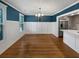 Elegant dining room with hardwood floors, decorative wainscoting, and stainless refrigerator at 932 Portabella Ln, Charleston, SC 29412
