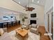 Cozy living room with hardwood floors, fireplace, ceiling fan and view of kitchen island at 932 Portabella Ln, Charleston, SC 29412