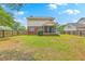 Large backyard featuring a screened in patio, wooden fence, and mature trees at 100 Cicero Ct, Goose Creek, SC 29445