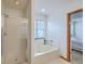 Bathroom features a glass-enclosed shower, soaking tub, and view to bedroom at 100 Cicero Ct, Goose Creek, SC 29445