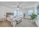 Bright bedroom features a ceiling fan, two windows, a bed and a decorative ladder shelf at 100 Cicero Ct, Goose Creek, SC 29445