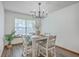 Bright dining room features a rustic table, modern lighting, and large window with natural light at 100 Cicero Ct, Goose Creek, SC 29445
