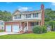 Charming two-story home with a brick facade, inviting front porch, a two-car garage and well-maintained lawn at 100 Cicero Ct, Goose Creek, SC 29445
