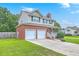 Two-story home with a brick and vinyl exterior, two-car garage, and a well-manicured lawn at 100 Cicero Ct, Goose Creek, SC 29445