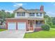 Charming two-story home with a brick facade, inviting front porch, a two-car garage and well-maintained lawn at 100 Cicero Ct, Goose Creek, SC 29445