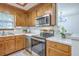 Well-lit kitchen with stainless steel appliances, wood cabinetry, and a breakfast bar at 100 Cicero Ct, Goose Creek, SC 29445