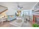 Open-concept living room with a fireplace, ceiling fan, comfortable seating and dining area at 100 Cicero Ct, Goose Creek, SC 29445