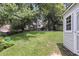 Well-maintained backyard with a storage shed, mature trees, and a lush green lawn at 100 Conset Bay Ct, Goose Creek, SC 29445