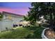 A spacious backyard featuring a lush green lawn, mature trees, and an inviting patio area for outdoor enjoyment at 100 Conset Bay Ct, Goose Creek, SC 29445