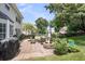 Outdoor patio area with a grill, fire pit, and comfortable seating surrounded by a manicured lawn at 100 Conset Bay Ct, Goose Creek, SC 29445