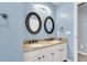 Stylish bathroom with a double vanity, granite countertop, white cabinets, and modern light fixtures at 100 Conset Bay Ct, Goose Creek, SC 29445