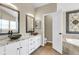 Bathroom with double sink vanity, granite countertop, vessel sinks, and decorative accents over the tub at 100 Conset Bay Ct, Goose Creek, SC 29445