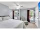 Bedroom with a large bed, a ceiling fan, two windows, and a comfortable reading chair at 100 Conset Bay Ct, Goose Creek, SC 29445