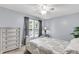 Comfortable bedroom with a ceiling fan and a large window for natural light at 100 Conset Bay Ct, Goose Creek, SC 29445