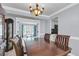 Dining room with hardwood floors leading to open living space and view of kitchen at 100 Conset Bay Ct, Goose Creek, SC 29445