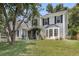 Stylish two-story home features gray siding, black shutters, a bay window, and a well-maintained lawn at 100 Conset Bay Ct, Goose Creek, SC 29445