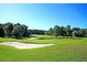 Scenic golf course view features lush greenery, mature trees, and a serene pond at 100 Conset Bay Ct, Goose Creek, SC 29445