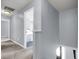 Upstairs hallway with neutral carpet, leading to a bedroom with light blue walls, and white trim at 100 Conset Bay Ct, Goose Creek, SC 29445