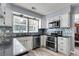 Bright kitchen with granite counters, stainless steel appliances, mosaic tile backsplash and wood-look vinyl flooring at 100 Conset Bay Ct, Goose Creek, SC 29445