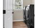 Laundry room featuring black washer and dryer appliances with a window bringing in natural light at 100 Conset Bay Ct, Goose Creek, SC 29445