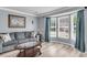 Comfortable living room with hardwood floors, bright bay window, and neutral decor at 100 Conset Bay Ct, Goose Creek, SC 29445