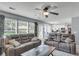 Spacious living room with cozy seating, ceiling fan, neutral color palette, and open access to the kitchen at 100 Conset Bay Ct, Goose Creek, SC 29445
