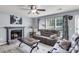 Cozy living room featuring a fireplace, comfortable seating, a ceiling fan, and great natural light at 100 Conset Bay Ct, Goose Creek, SC 29445