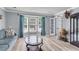 Bright and airy living room featuring a bay window, hardwood floors, and neutral color palette at 100 Conset Bay Ct, Goose Creek, SC 29445