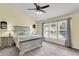 Main bedroom featuring a vaulted ceiling, ceiling fan, carpet flooring, and a large window offering plenty of natural light at 100 Conset Bay Ct, Goose Creek, SC 29445