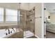 Contemporary bathroom featuring a tiled shower with glass door, a soaking tub, and natural light at 100 Conset Bay Ct, Goose Creek, SC 29445