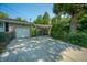 Driveway and backyard featuring a detached garage and large trees providing shade at 100 S Gum St, Summerville, SC 29483