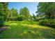 Backyard featuring a grassy lawn and mature trees at 100 S Gum St, Summerville, SC 29483