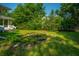 Backyard retreat featuring a charming small pond with surrounding greenery and partial view of the home's rear exterior at 100 S Gum St, Summerville, SC 29483