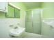 Functional bathroom with tiled walls, standard sink, a mirrored medicine cabinet and glass-enclosed shower at 100 S Gum St, Summerville, SC 29483