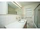 Traditional bathroom featuring a vanity, commode, and bathtub with a shower, and neutral-toned tile at 100 S Gum St, Summerville, SC 29483