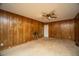 Bedroom featuring wood paneling, carpet, and ceiling fan at 100 S Gum St, Summerville, SC 29483