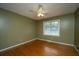 Cozy bedroom with hardwood floors, a window for natural light, and a ceiling fan for added comfort at 100 S Gum St, Summerville, SC 29483