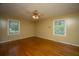 Comfortable bedroom with hardwood floors and two windows providing ample natural light at 100 S Gum St, Summerville, SC 29483