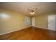 Inviting bedroom featuring hardwood floors, a ceiling fan, and a window that brightens the space at 100 S Gum St, Summerville, SC 29483