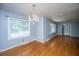 Dining room with hardwood floors, gray paint, chandelier, and multiple windows at 100 S Gum St, Summerville, SC 29483