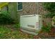 Exterior view of the Generac whole-house generator with a partial brick exterior of the home at 100 S Gum St, Summerville, SC 29483