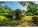 Brick home exterior showcasing lush green lawn, mature trees, and a whole-house Generac generator system at 100 S Gum St, Summerville, SC 29483