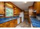 Kitchen showcasing wood cabinets, blue countertops, and stainless steel appliances at 100 S Gum St, Summerville, SC 29483
