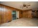 Living room with wood paneling, ceiling fan, carpet, and sliding glass doors at 100 S Gum St, Summerville, SC 29483