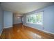 Bright living room with hardwood floors, fresh gray paint, and a large window at 100 S Gum St, Summerville, SC 29483