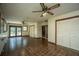 Spacious living room with tile flooring, multiple windows, ceiling fans, and access to the backyard at 100 S Gum St, Summerville, SC 29483