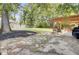 Spacious backyard featuring a large lawn, mature trees, and an inviting pergola-covered patio at 103 Trimley Ct, Goose Creek, SC 29445