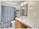 Clean bathroom with wooden vanity, soft lighting, and a shower-tub combo at 103 Trimley Ct, Goose Creek, SC 29445