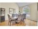 Dining room with large window, hardwood floors, and table with seating for eight at 103 Trimley Ct, Goose Creek, SC 29445