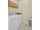Functional laundry room with washer, dryer, cabinets, and tile flooring at 103 Trimley Ct, Goose Creek, SC 29445